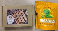 Book Genre Bingo Prize 1 is a DIY Leathercraft Bookmark Kit and Prize 2 is a Fred the Dinosaur, The Woobles Crochet Kit.