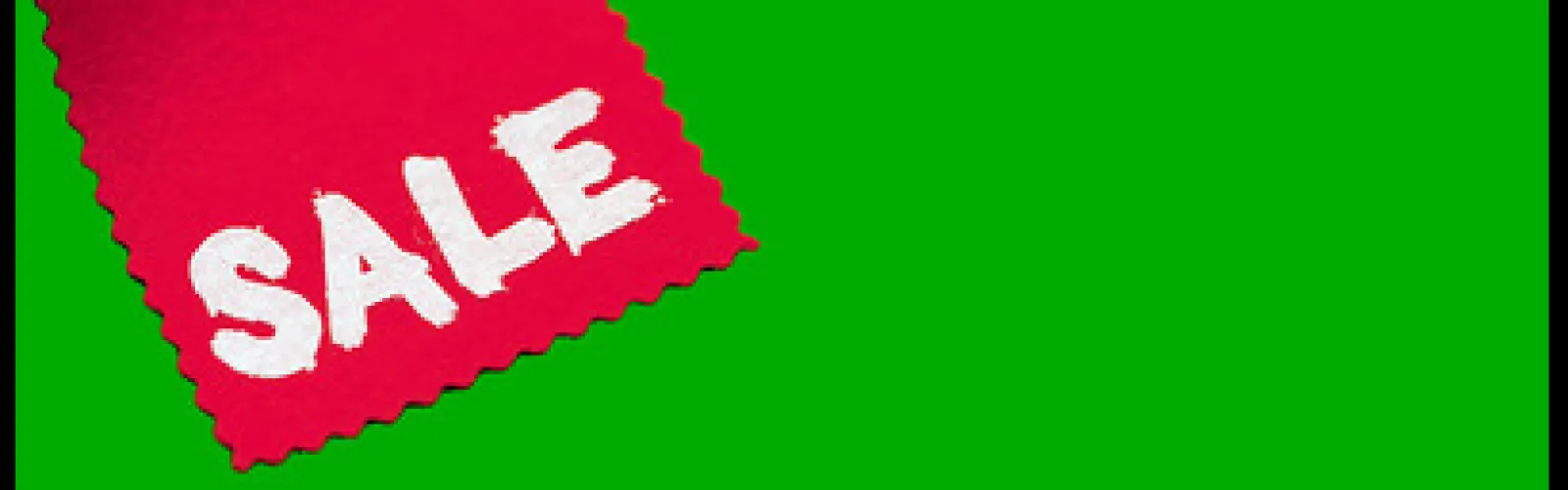 red and white sale tag on green background